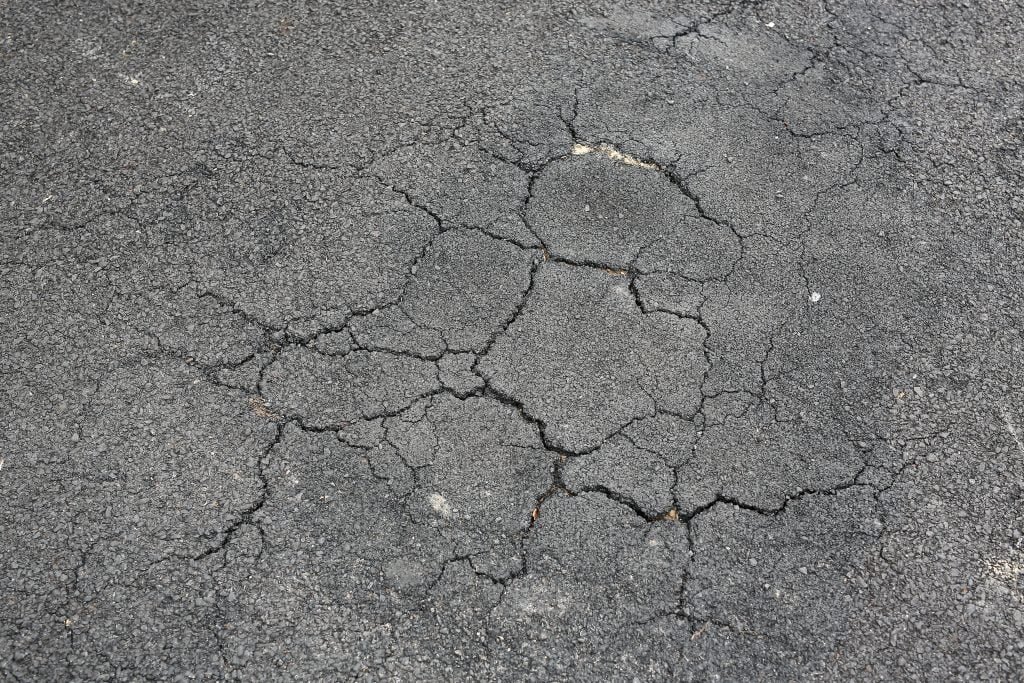 Cracked Asphalt Background. Cracked Asphalt Background.